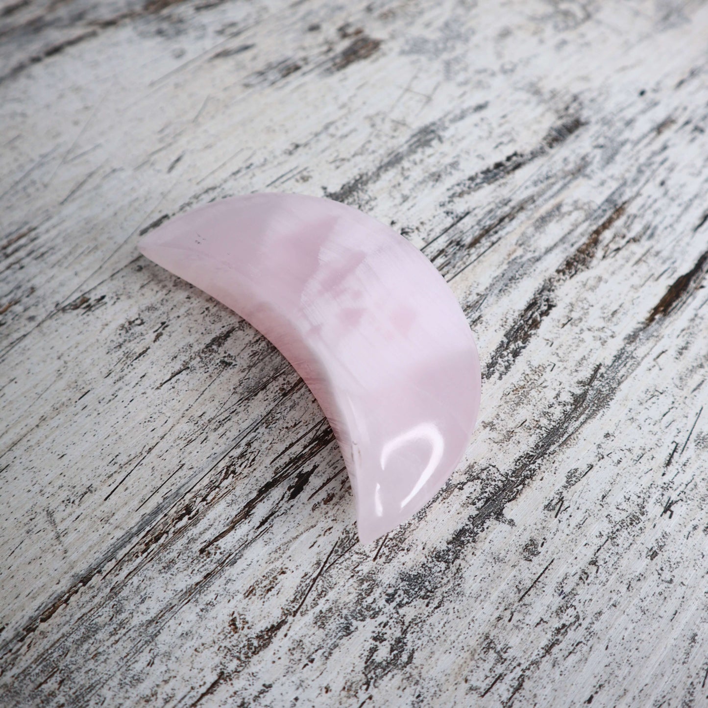 Mangano Calcite crescent moon with gentle, nurturing energy.