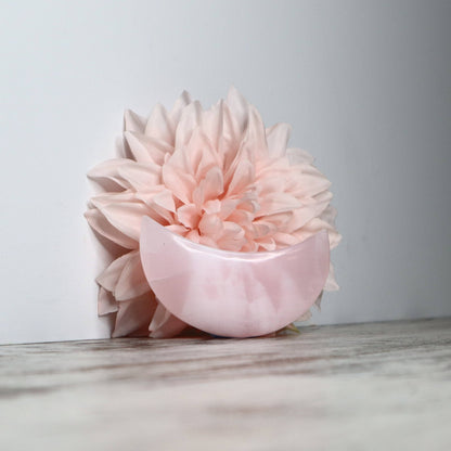 Polished Mangano Calcite moon carving with soft pink tones.